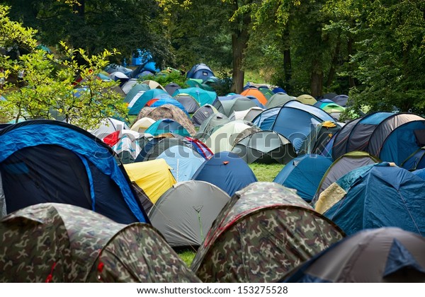 Many tents at a festival\
campsite 