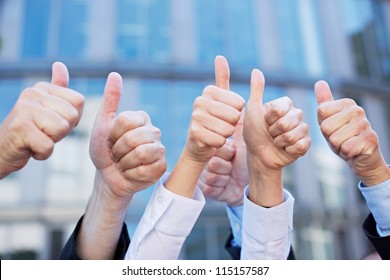 Many Thumbs Of Different Business People Pointing Up