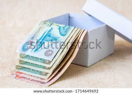 Many UAE Dirham Banknotes in white gift box. Studio Shot.