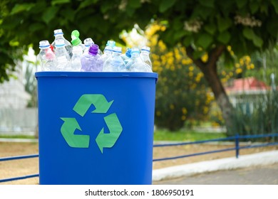 Many used bottles in trash bin outdoors, space for text. Plastic recycling - Shutterstock ID 1806950191