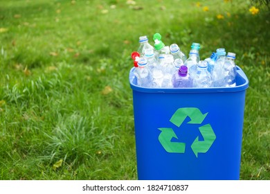 Many used bottles in trash bin outdoors, space for text. Plastic recycling - Shutterstock ID 1824710837