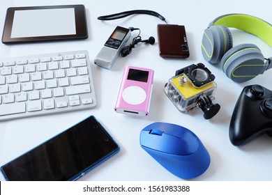 Many used modern Electronic gadgets for daily use on White floor, Reuse and Recycle concept, Top view. - Shutterstock ID 1561983388