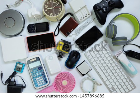 many used modern Electronic gadgets for daily use on White floor, Reuse and Recycle concept, Top view.