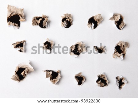 many various holes in the white paper