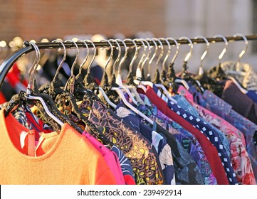 Many Vintage Style Clothes  For Sale At An Outdoor Flea Market