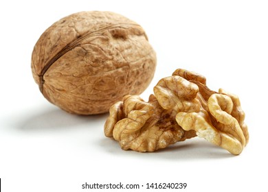 many walnuts scattered on a white table, macro