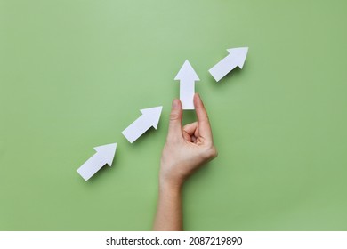 Many white arrows point to the left, and one arrow points up. A symbol of an innovative, different way of life and business - Shutterstock ID 2087219890