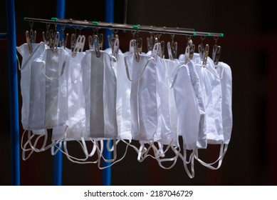 Many White Cloth Face Masks Hanging In The Sun After Washing