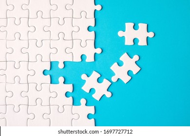 Many white jigsaw puzzle on blue background - idea solution concept. - Shutterstock ID 1697727712