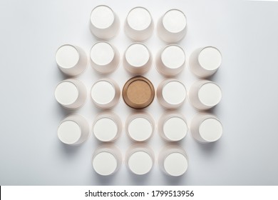 Many White And One Brown Paper Cups Flipped Upside Down On A Light Background. Top View, Flat Lay