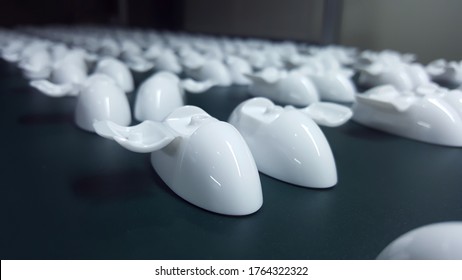 Many Of The White Plastic Pieces That Come Out Of The Injection Molding Machine Are Arranged In Rows,soft Focus