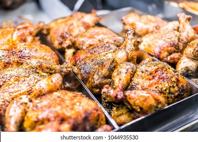 Many Whole Chicken Roasted Closeup On Tray In Deli Display Store Shop Grocery Brown With Herbs, Golden Skin, Spices, Crispy