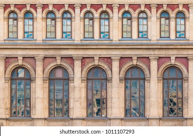 Many windows in a row on the facade of the urban historic building front view, Saint Petersburg, Russia