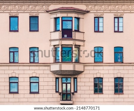 Many windows in a row on the facade of the urban historic apartment building front view, Saint Petersburg, Russia