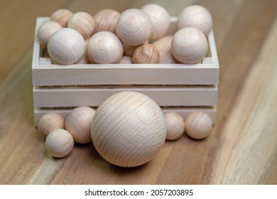 Many wooden balls in a wooden box