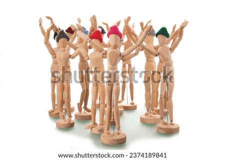 Many wooden mannequins with winter hat isolated over white