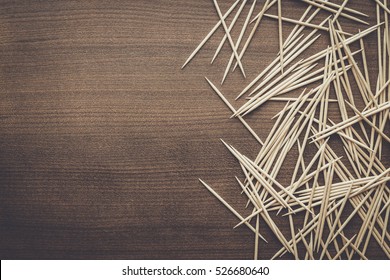 many wooden toothpicks on the brown table background