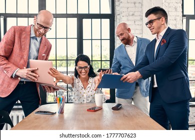 Too many work. Selective focus of young business woman surrounded by colleagues, each proposes a project, asks for approval or signing. Deadline