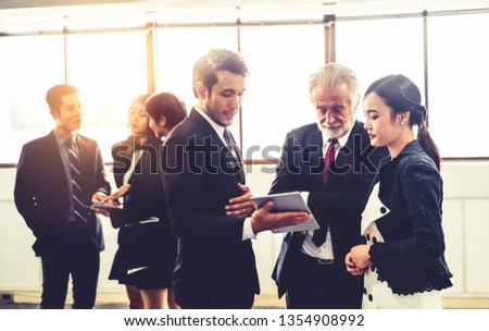 Many young businessmen and businesswomen in group meeting standing at conference hall in the office. Multicultural company organization unity and support. Concept of partnership and human resources.