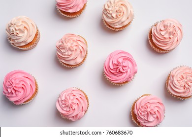 Many yummy cupcakes on white background
