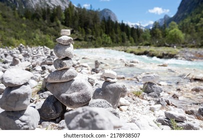 Many zen stones, rock pyramids, cairn, stone piles. Idyllic landscape in the alps with turquoise water. - Powered by Shutterstock