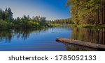 Manzanita lake at twilight with forest reflecting in water in July. Landscape photo with peaceful and relaxing atmosphere. Mirror effect on the lake and no people.