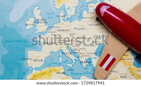 A map of Austria and a red plane with a flag of Austria attached to its wings.