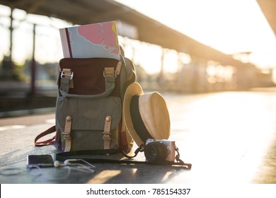 Map in Backpack ,Mobile phone with earphone and hat at the train station with a traveler.sun set, Travel concept. - Shutterstock ID 785154337