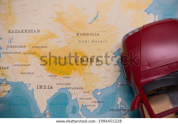A map of China and a red\
car.