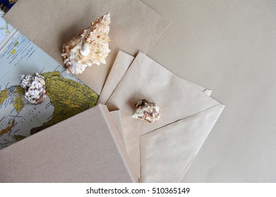 Map, craft papers and shells on the desk.The view from the top.