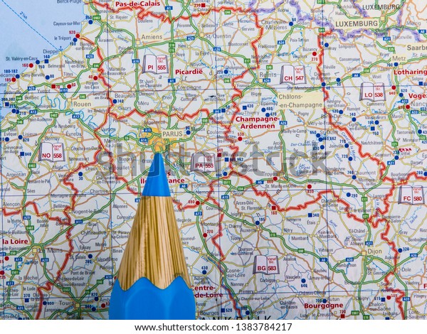 Map of France with point of blue pencil on\
Paris, view from above,\
close-up.