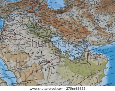 Map of Middle Eastern countries arranged with creative elements, featuring a pen and pointer on one section and a paper origami boat on another. The composition blends geography with travel and navigation concepts, creating a unique visual ideal for themes related to exploration, education, planning, and cultural regions of the Middle East