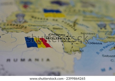 map of moldova with its flag next to it, close up and horizontal shot