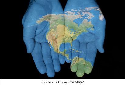 Map painted on hands showing concept of having North America in our hands