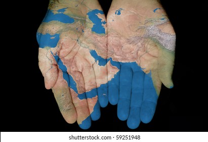 Map painted on hands showing concept of having the Middle East in our hands
