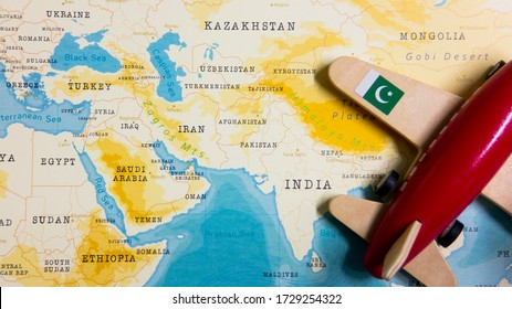 A map of Pakistan and a red plane with a flag of Pakistan attached to its wings. - Shutterstock ID 1729254322