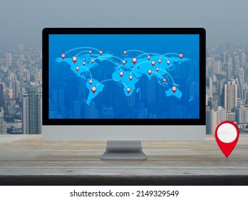Map pin location button with connection line and world map on computer screen on table over city tower and skyscraper, Map pointer navigation online concept, Elements of this image furnished by NASA