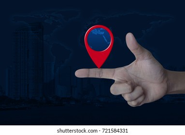 Map pin location button on finger over world map and modern city tower, Map pointer navigation concept, Elements of this image furnished by NASA