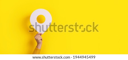 map pointer 3d pin in hand over yellow background