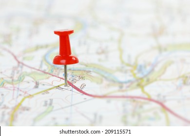 Map with red pushpin marking destination. Shallow dof. 
