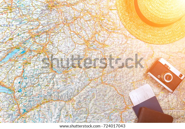 Map of roads with\
a vintage camera, passport, sunglasses. View from above. The\
concept of travel. Sun\
flare