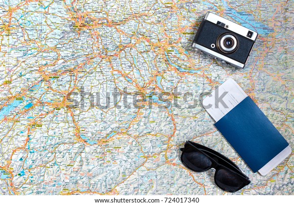 Map of roads with a vintage\
camera, passport, sunglasses. View from above. The concept of\
travel