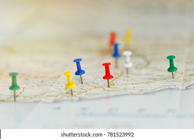 Map of a sea shore with route highlights and places of interest marked by colored pins. Vacations preparations idea, route planning concept. Close-up capture, selective focus, unrecognizable names.