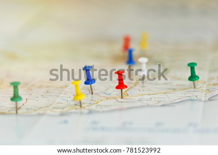 Map of a sea shore with route highlights and places of interest marked by colored pins. Vacations preparations idea, route planning concept. Close-up capture, selective focus, unrecognizable names.