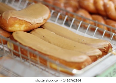 Maple Bars On Display Racks At The Donut Shop.