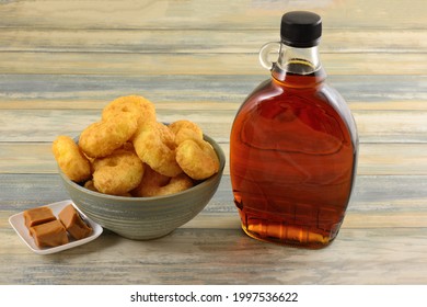 Maple Caramel Corn Puffs Snack In Bowl With Caramel Squares And Bottle Of Maple Syrup