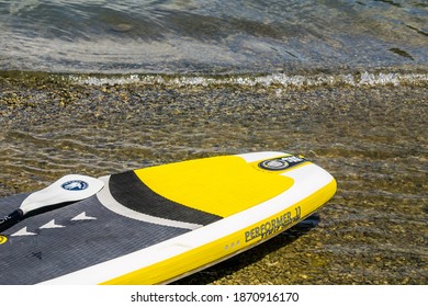 MAPLE RIDGE, CANADA - JUNE 28, 2020: Stand Up Paddle Board At Lake Shore With Clear Water