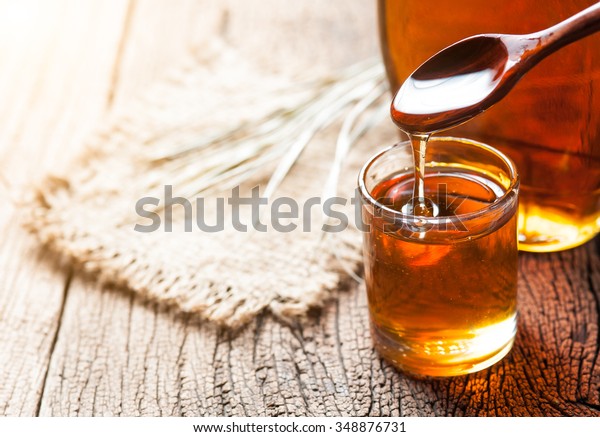 maple syrup in
glass bottle on wooden
table