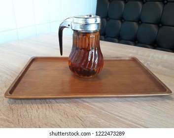 Maple Syrup In Glass Jar On Wooden Table.