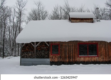 A Maple Syrup Sugar Shack In Rural Quebec Covered In Snow.